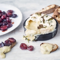 Baked camembert with cherries and herbs